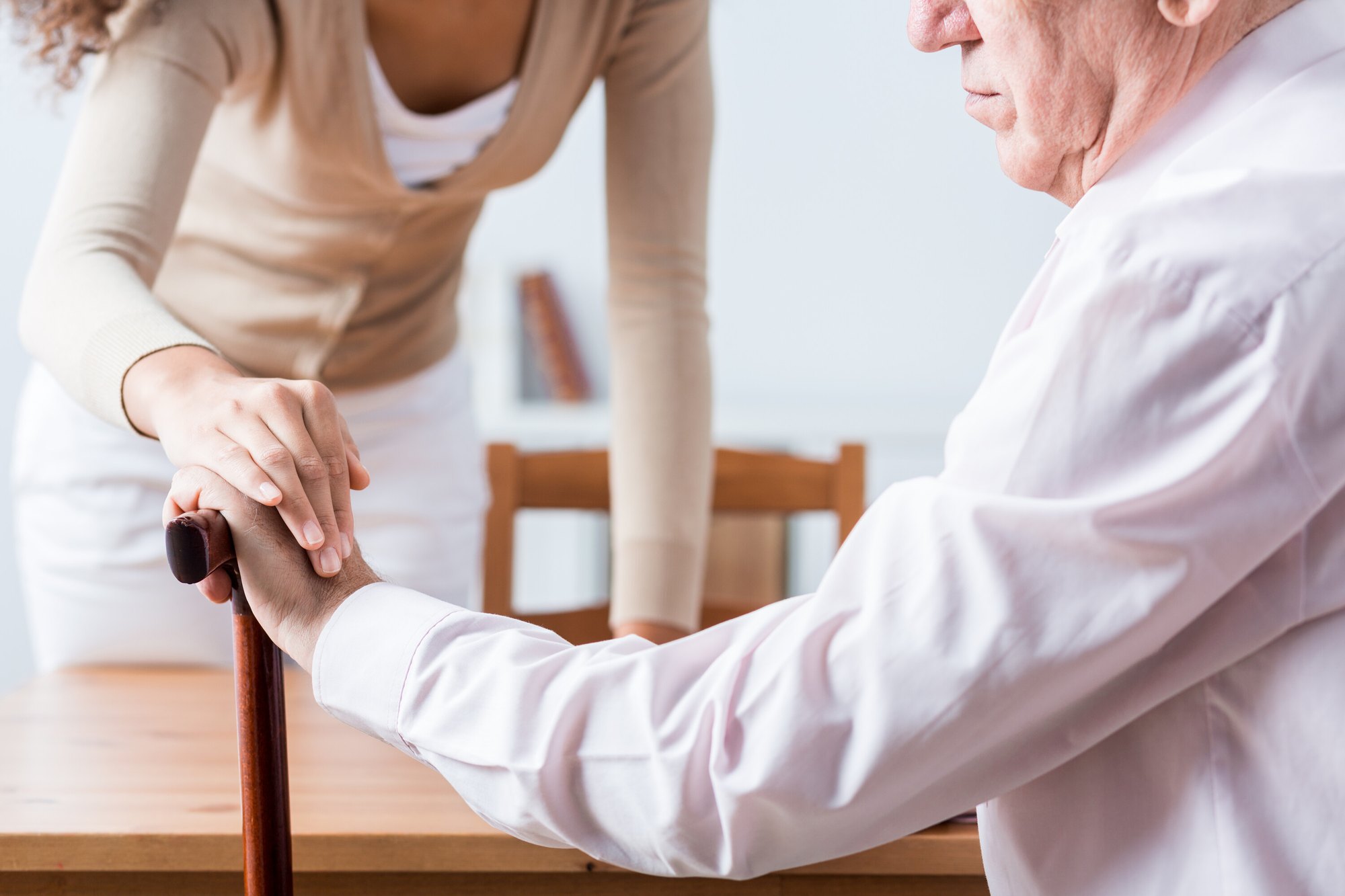 An older adult works through a gentle knee exercise with a physical therapist