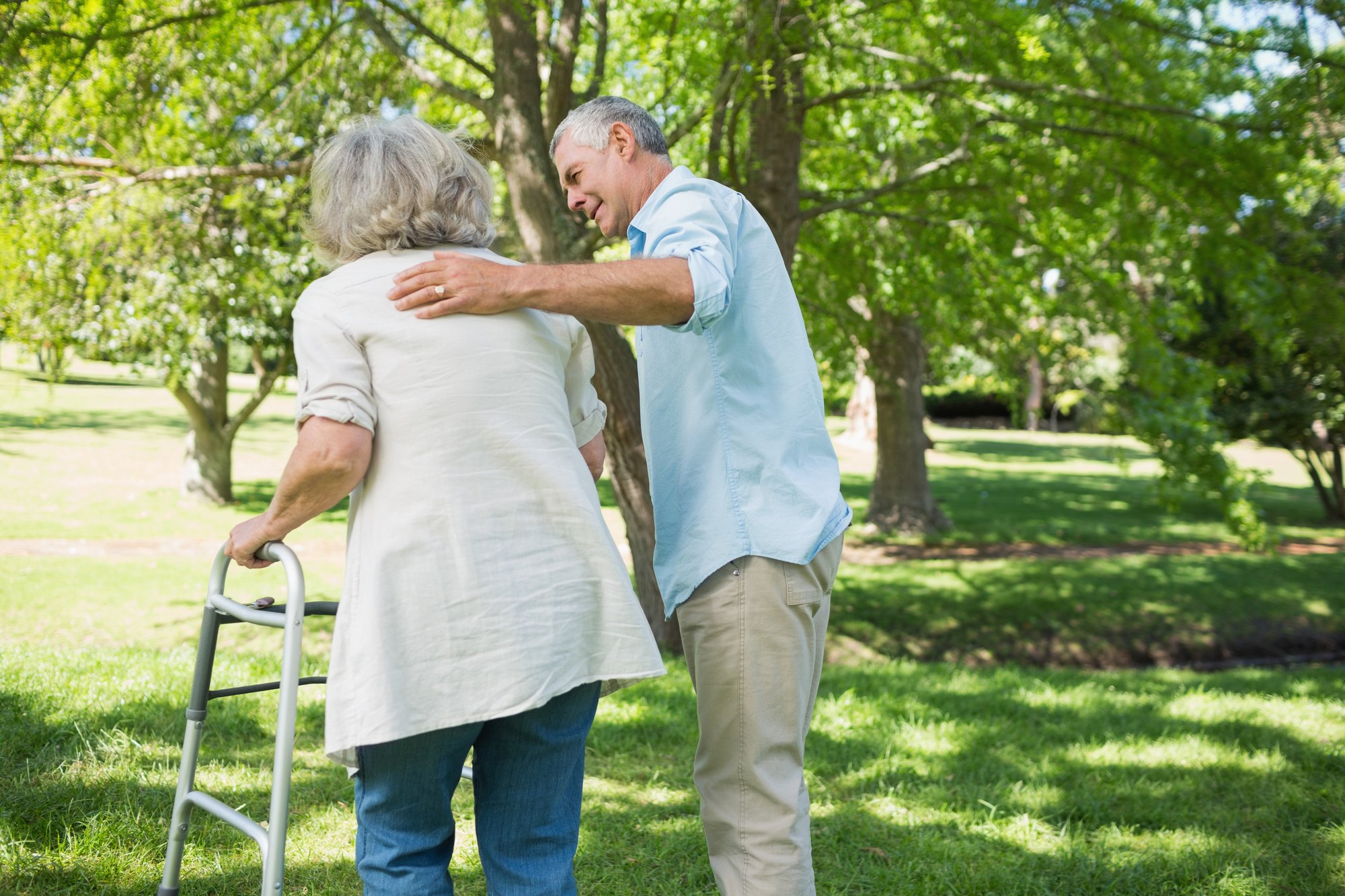 An older adult takes a breath during a rest between exercises with a physical therapist